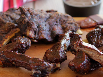 Grilled ribs on a wood serving board.
